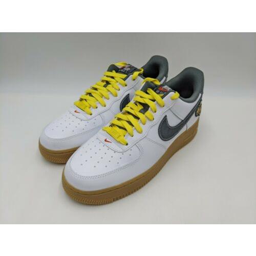 white nike shoes with yellow swoosh