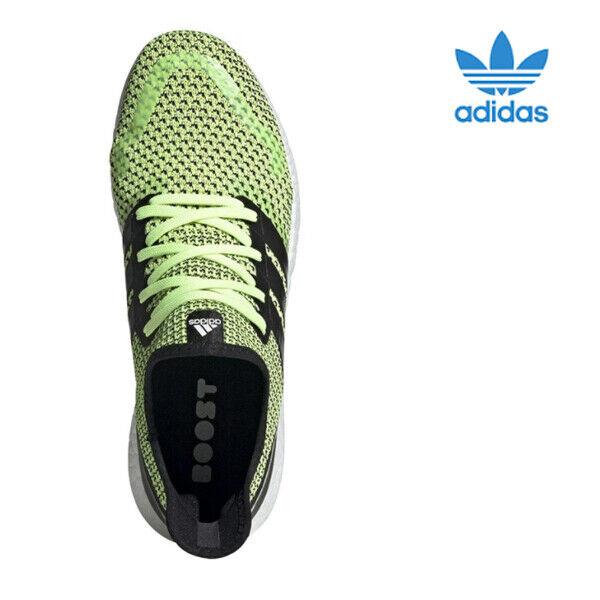 neon green and black adidas shoes