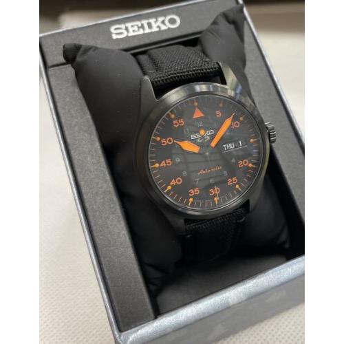 Seiko watch  - Dial: Black Dial And Orange Hands And Numbers, Band: Black In Front , Orange At The Back