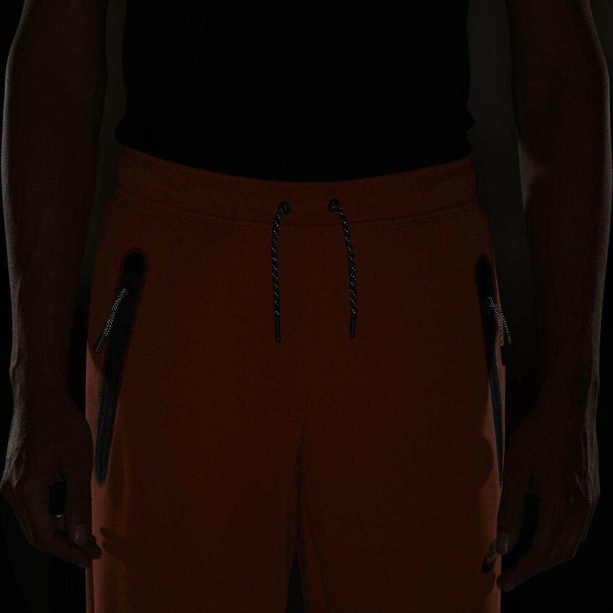 nike tech open hem pants