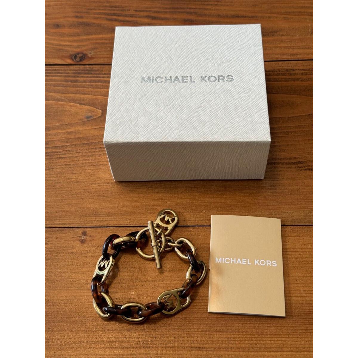 Michael Kors Women`s Tortoise Gold-tone Steel Dangle Toggle Closure Bracelet