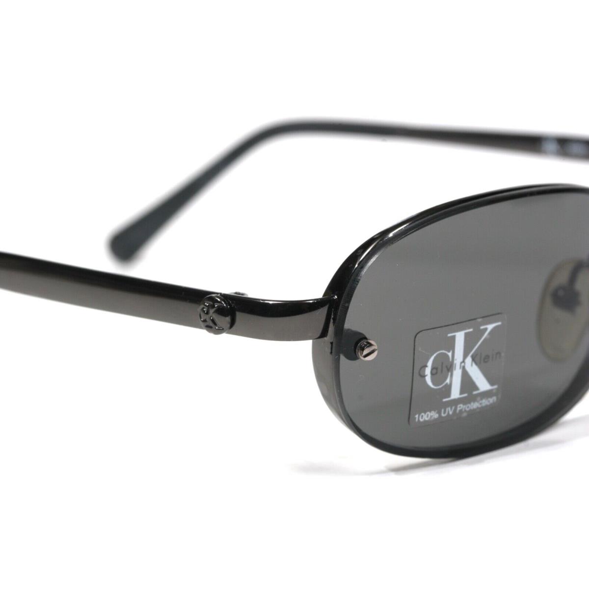 Calvin Klein CK 2020 30 52 18-135 Metal Frame Gray Lens Round D100