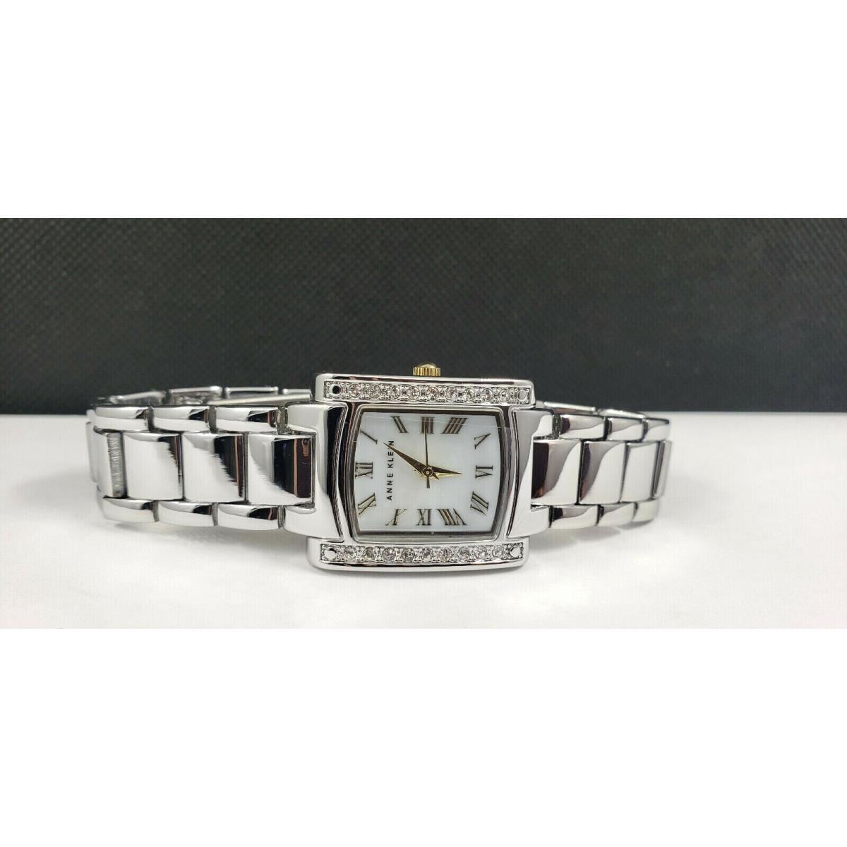 Anne Klein AK/1699MPTT Crystal Accented Mother-of-pearl Dial Women`s Watch